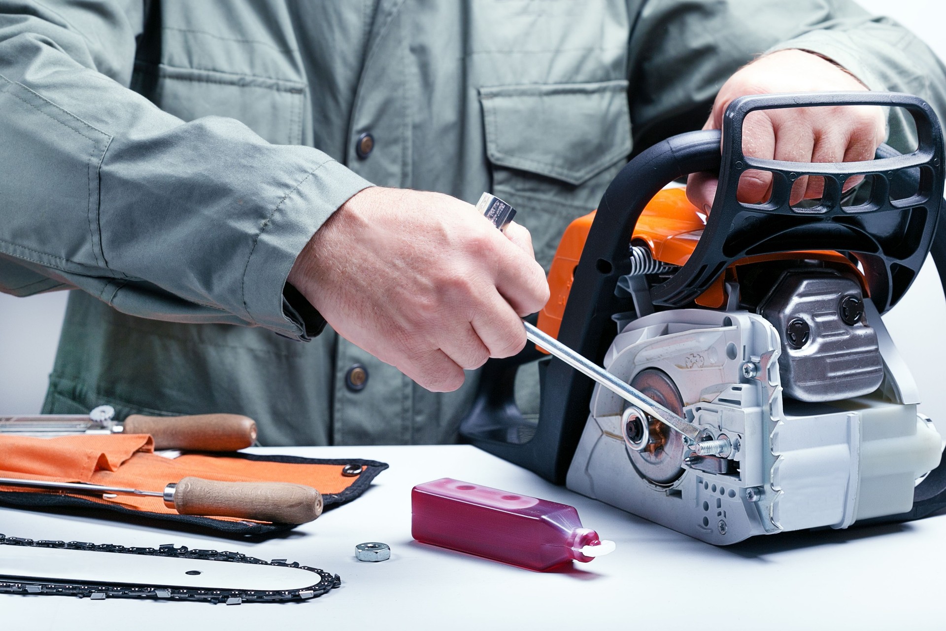 Man repairing chainsaw.